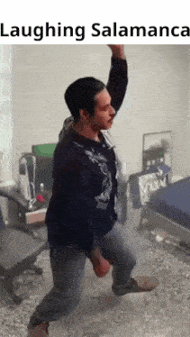 a man is standing in a room with his arms in the air while laughing .
