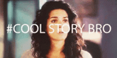 a woman with long curly hair is standing in front of a sign that says `` cool story bro '' .
