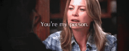 a woman in a plaid shirt is talking to another woman and says you 're my person