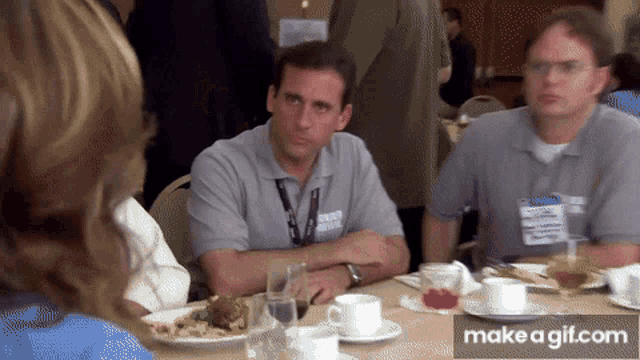 a man with a name tag that says ' dwight schrute ' on it