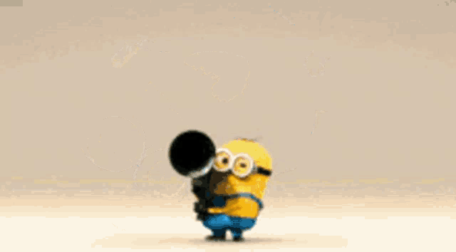 a yellow and blue minion is doing a handstand on its head