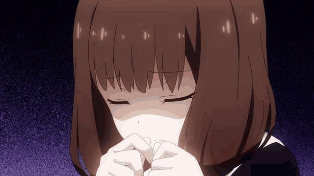 a girl with brown hair is praying with her eyes closed and her hands folded