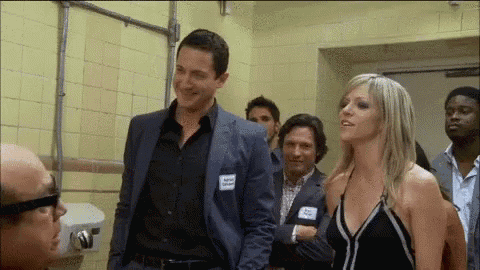 a man and a woman are standing next to each other with a man wearing a name tag that says kevin
