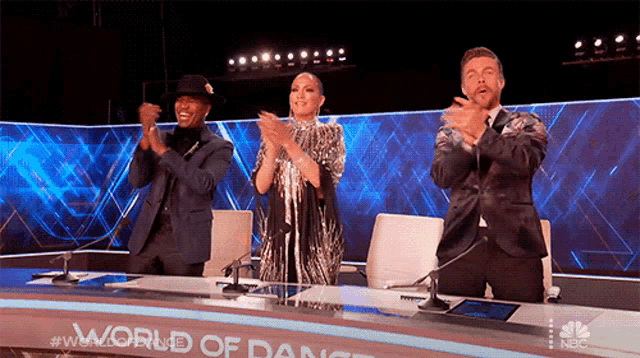 a group of people sitting at a table with the words world of dance on the bottom
