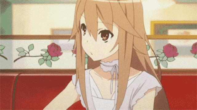a girl with long brown hair is sitting on a red chair