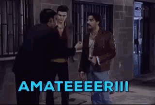 a group of men are walking down a street and the word amateeeriii is written in blue