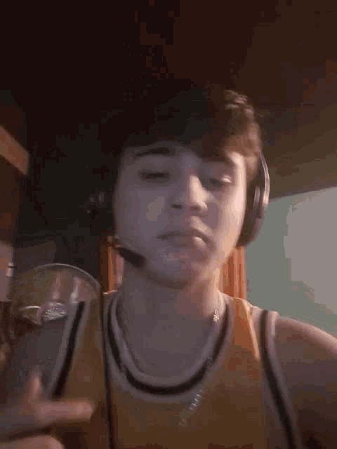 a young man wearing headphones and a yellow jersey