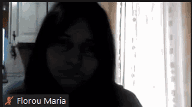a screen shot of a woman with the name florou maria on the bottom left