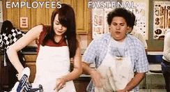 a man and a woman are standing in a kitchen with the words employees fastenal written on the bottom .