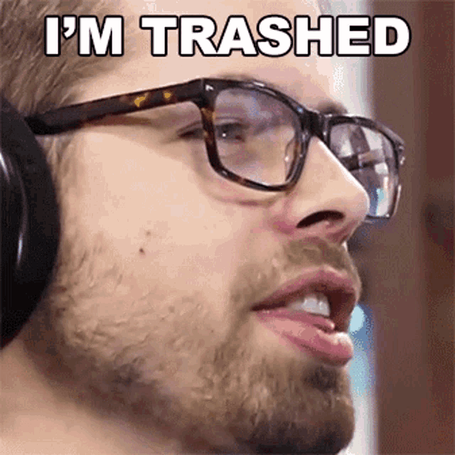 a man wearing glasses and headphones with the words i 'm trashed above his face