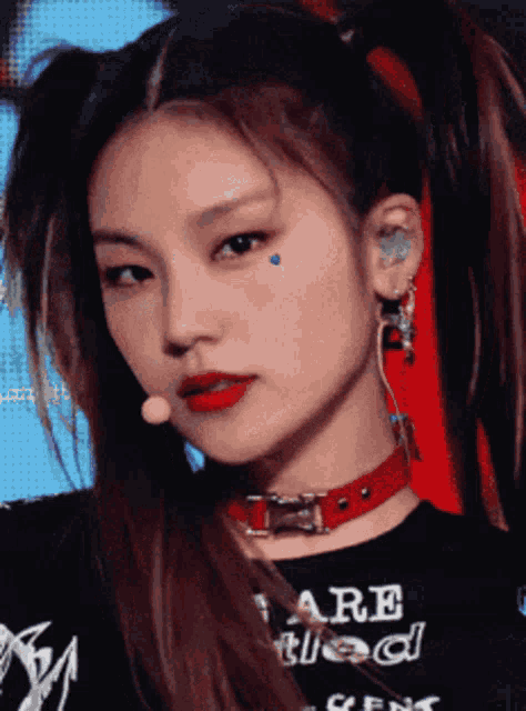a close up of a woman wearing a red choker