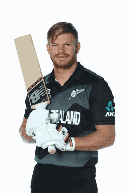 a man wearing a new zealand shirt stands in front of a white background