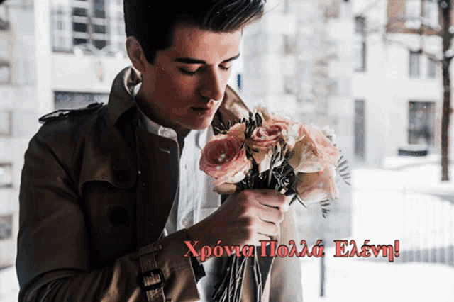 a man holding a bouquet of flowers with a greeting in another language