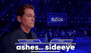 a man in a suit stands in front of a sign that says ashes densideeye