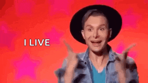a man wearing a hat and a denim jacket is making a funny face while saying `` i live '' .