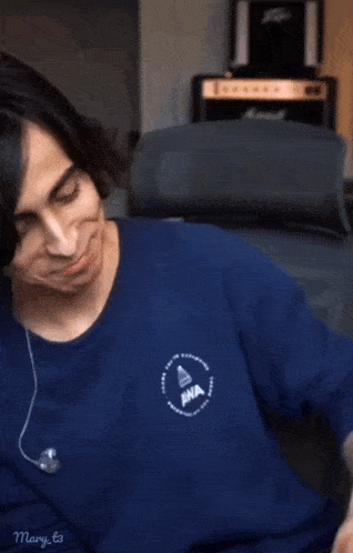 a man wearing a blue shirt with iwa on it