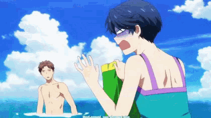 a man and a woman are standing in the water and the woman is holding something in her hand