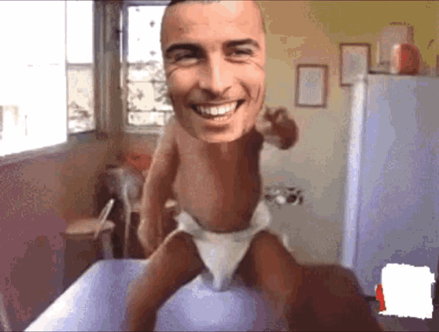 a baby in a diaper has a man 's face on it