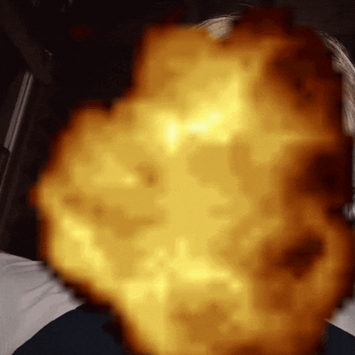 a person laying on a bed with a blurred image of a fireball in the background