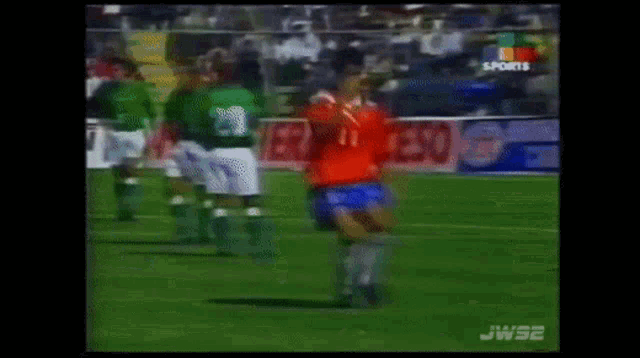 a soccer player in a red jersey with the number 11 on the back