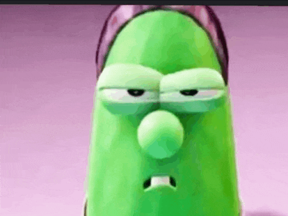 a close up of a green cartoon character with a sad face .