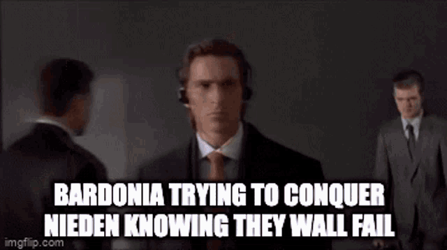 a man in a suit and tie is wearing headphones and standing in front of a wall .