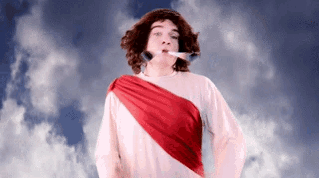 a man dressed as jesus with a brush in his mouth