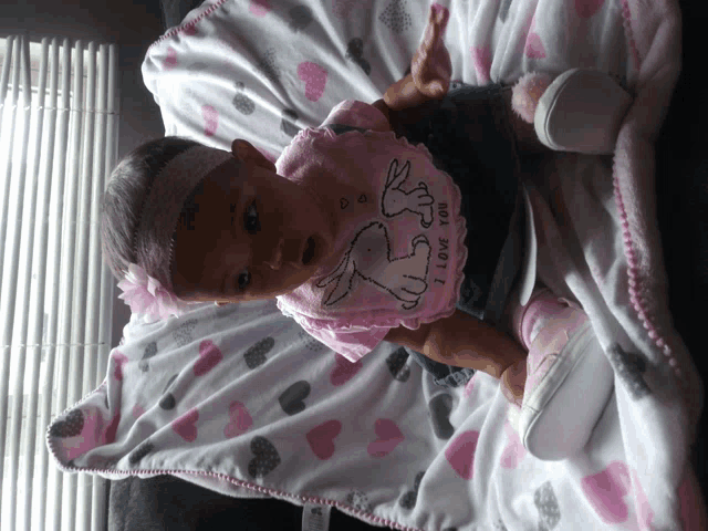 a baby wearing a pink shirt that says " i love you "