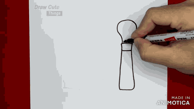 a person is drawing a brush on a piece of paper