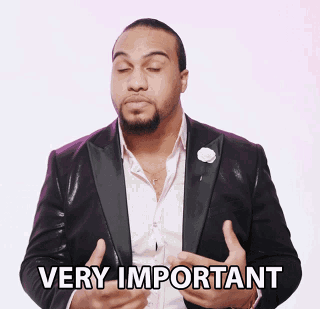 a man in a suit says very important with his hands outstretched
