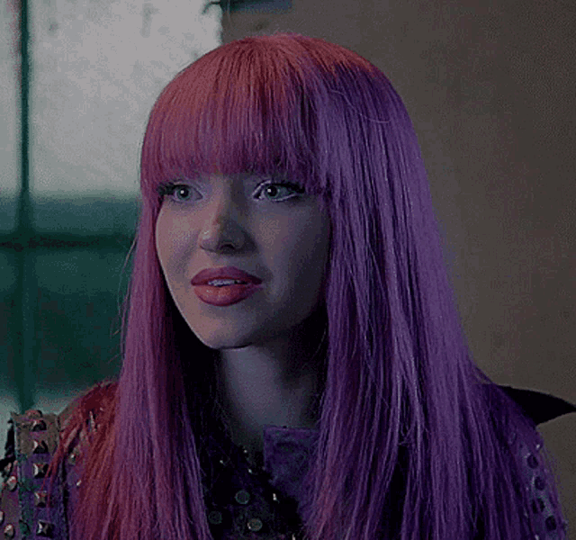 a close up of a woman with purple hair