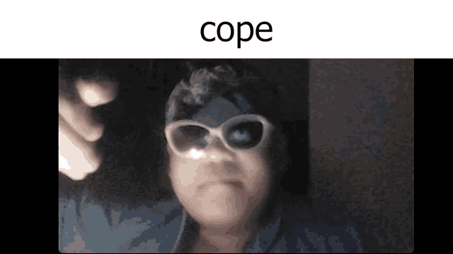 a person wearing sunglasses and a bandana is making a face .
