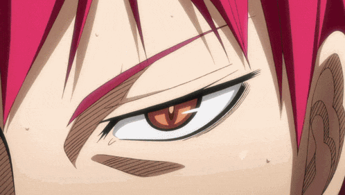 a close up of a person 's face with red hair and brown eyes