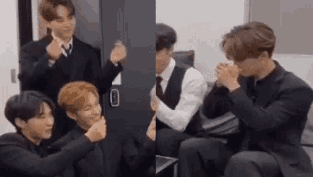 a group of men in suits and ties are sitting next to each other and making heart shapes with their hands .