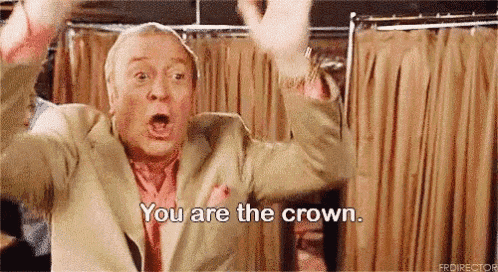 a man in a suit and tie is screaming and saying `` you are the crown . ''