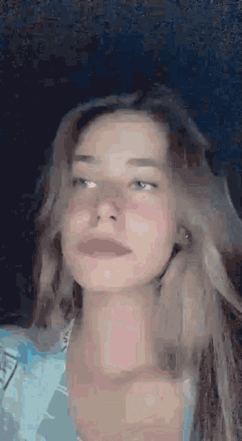 a close up of a woman 's face with red cheeks and a pink nose .