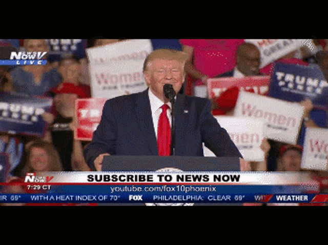 donald trump is giving a speech in front of a crowd with signs that say women