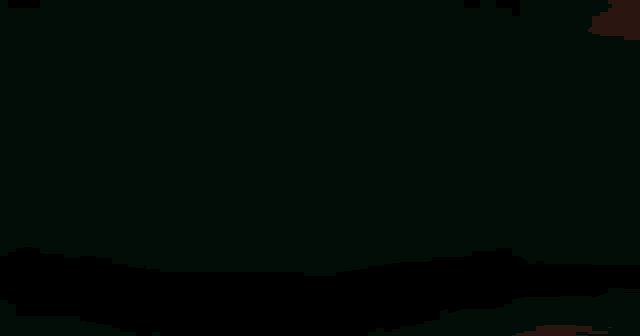 a blurry picture of a man 's face with a green background