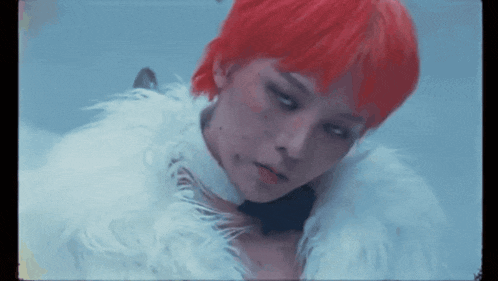 a woman with red hair is wearing a fur coat