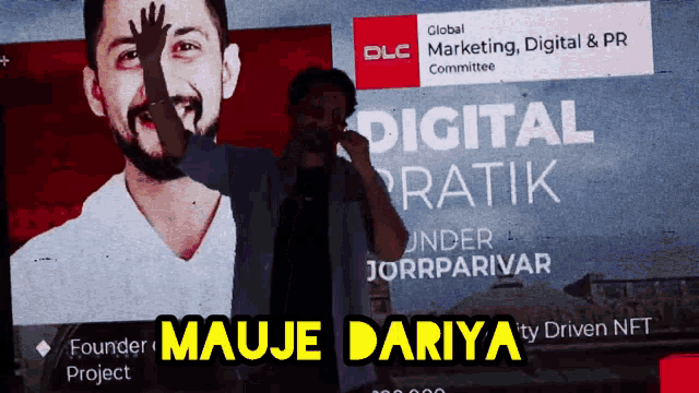a man stands in front of a screen that says digital ratik