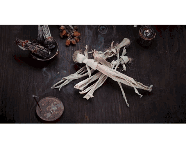 a wooden table with incense sticks and dried flowers