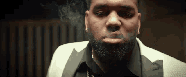 a man with a beard is smoking a cigar
