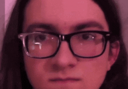 a close up of a person 's face wearing glasses .