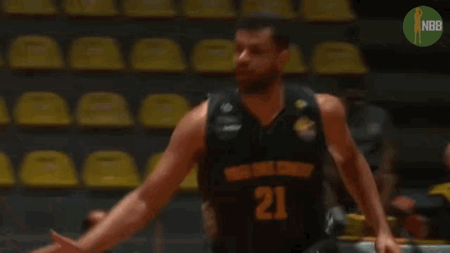 a basketball player with the number 21 on his jersey is running with the ball