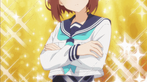 a girl with her arms crossed stands in front of a yellow background