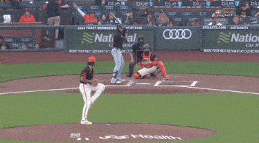 a baseball game is being played in front of a banner that says tional car rental