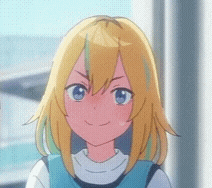 a girl with blonde hair and blue eyes is smiling and looking at the camera .