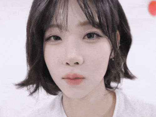 a close up of a girl 's face with a white shirt on