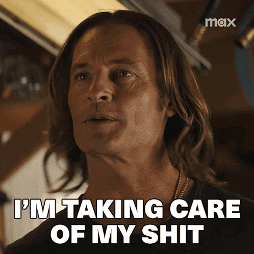 a man with long hair is taking care of his shit