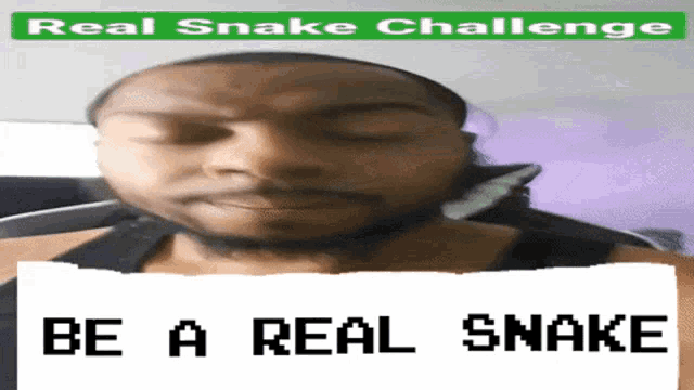 a man with his eyes closed has a sign that says be a real snake